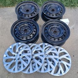 Four 16 inch wheels with lug nuts and wheel lock including hub caps
