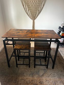 Counter-height wooden dining table set with 4 matching stools - great condition