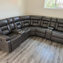 New Reclining Sectional .  Grey Gel Leatherette .  106” X 106”.  Free Delivery !