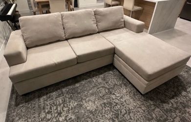 Sand beige Living Spaces Bonaterra Sectional (Reversible chaise)