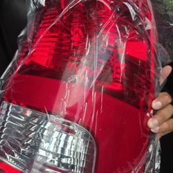 left-side tail light lens and housing for a Dodge Ram truck, likely from the model years 2009-2017. 