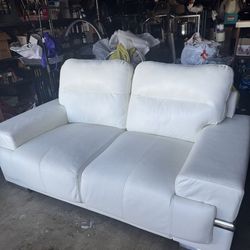 White leather loveseat and single chair