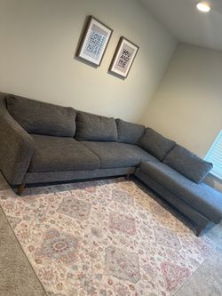 A tv stand and couch