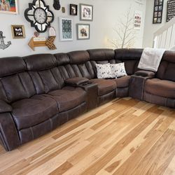 GUC large, brown leather power reclining sectional featuring 2 console storage with cupholders.