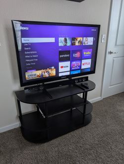 Samsung 43" TV, Samsung sound bar and subwoofer, Roku stick, and entertainment center