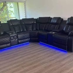Electric reclining sectional sofa with LED and speakers.