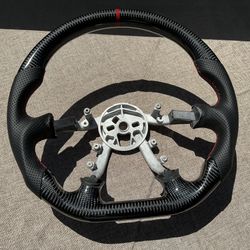 1(contact info removed) Corvette C-5 Carbon Fiber Steering Wheel Black Perforated Leather Red Center Stripe. 