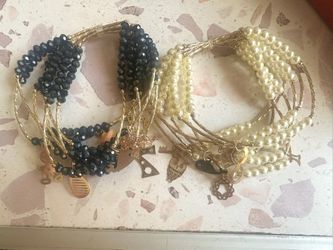 Stainless steel, gold age bracelet. Has seven tiny bracelets.