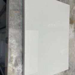 Unopened Canvas With Paint And Brushes 