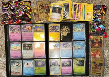 Pokemon cards. Stack of old cards, a book filled and bunch of packs