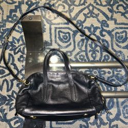 Like new excellent condition Black pebbled leather  Silver adjustable chain  Interior zipper pocket Snap closer Lining is spotless