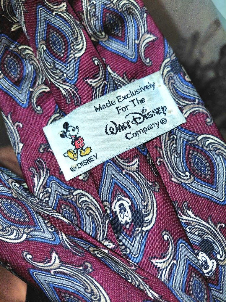 This is a vintage Walt Disney Company Mickey Mouse red silk necktie with a novelty print.