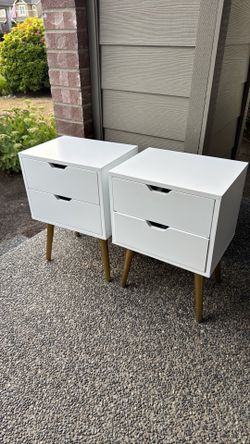 Two white nightstands with golden legs