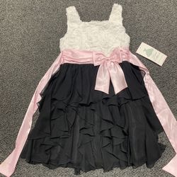 Brand new Rare Editions girls size 12 white rosette-patterned bodice, a black cascading chiffon ruffle skirt, and a contrasting pink satin sash with a