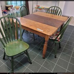 Table and 4 chairs table has 2 leaves.