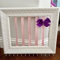 Adorable Girls Hair Bow And Jewelry Accessory Holder   Has hooks on the bottom for necklaces or jewelry or hair ties.  Hangs on the wall.  In good con