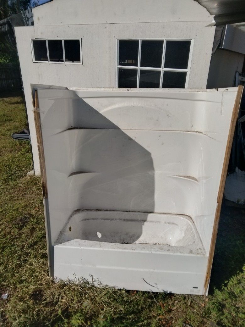 This is a multi-piece bathtub and shower unit.