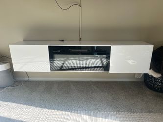 Floating entertainment center with electric fireplace.