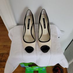 Bandolino black and white patent leather cap-toe heels.