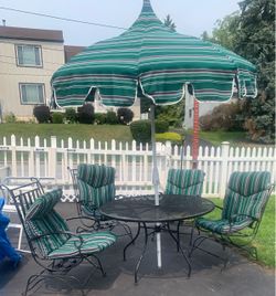 5 piece patio set. Wrought iron table and chairs  Sunbrella umbrella and chair cushions