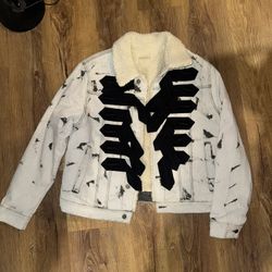 Giambattista Valli x H&M distressed denim jacket with a sherpa lining and large black appliqué detailing