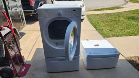 White Frigidaire electric dryer with two pedestals with drawers