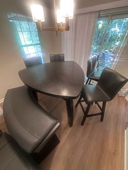 Unique Dark Wood Triangular Counter Height Dining Set with Bench and 4 Leather Chairs.