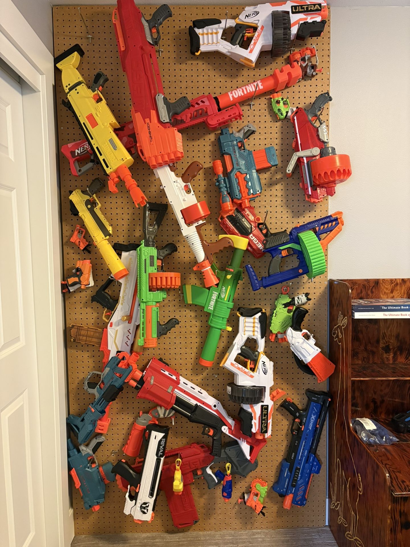 Custom built Nerf wall for 8’ ceiling with 30+ nerf guns, darts & more