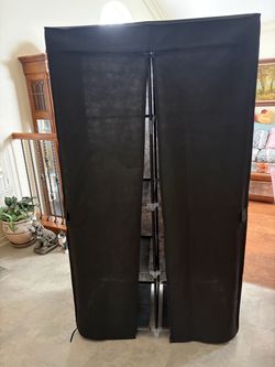 Black fabric wardrobe closet with rods and shelves