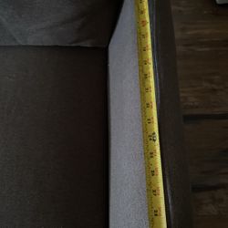 The Sofa Color  is dark brown . 
