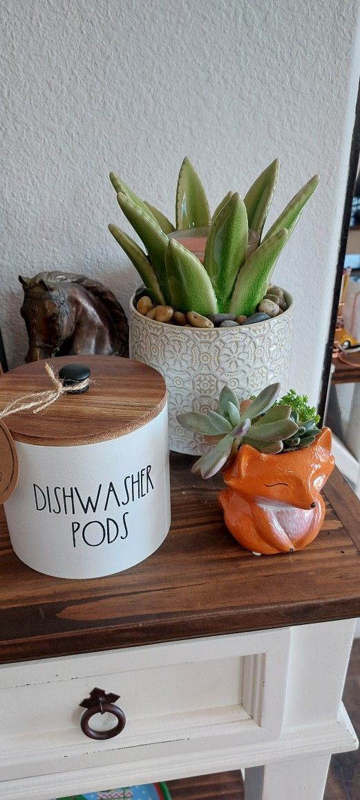 Rae Dunn Inspired White Jumbo Dishwasher Pods Storage Container with lid in a medium oak wood tone and a black handle. An adorable little storage solu