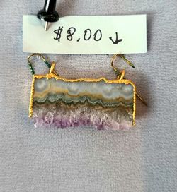 Natural amethyst and agate druzy slice pendant features a combination of banded agate and purple crystals. This piece has a gold-toned electroplated t