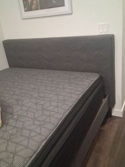 Queen platform grey bed.