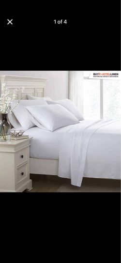 White bedsheets, pillowcases, duvet, duvet covers, towels, pillows.