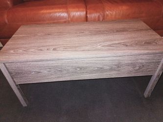 Coffee table with rising top.
