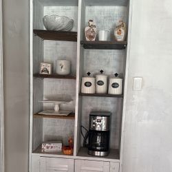 White shelving unit with decor & bottom drawers