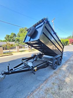 NEW DUMP TRAILER 8X12X4 12000 LBS
ROLLING TARP--SPARE TIRE,ELECTRIC BRAKES,HYDRAULIC SYSTEM,REMOTE CONTROL,IDEAL FOR HAULING, DEMOLITION, TRASH ETC,FO