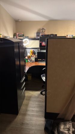 Cubicle over head cabinet with lights, desk, locker and shelves