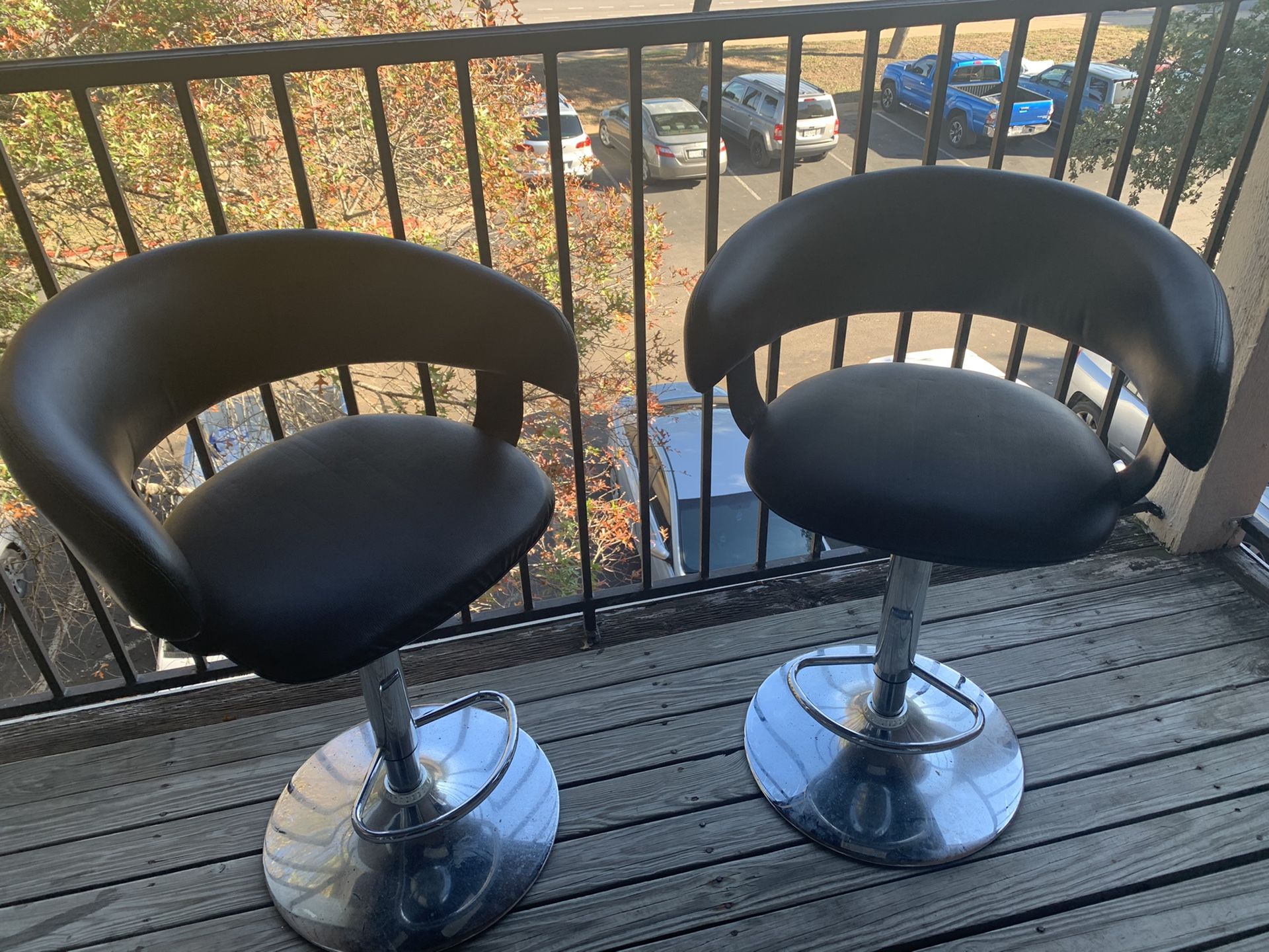 Two faux leather bar stools
