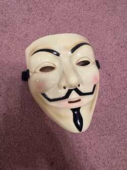 Iconic Guy Fawkes style mask by iHeartRaves. Cream base with bold black mustache, goatee, and brows. Subtle pink blush on the cheeks. Elastic strap fo