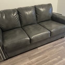 Like New - Faux Leather Sofa - Pull Out Bed Full Size Mattress - ( Ashley Furniture )