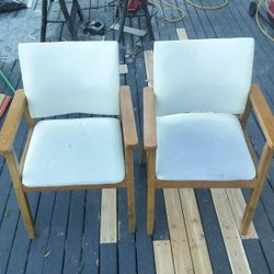 mid-century modern solid wood arm chair with a cream faux leather upholstered seat and backrest. 