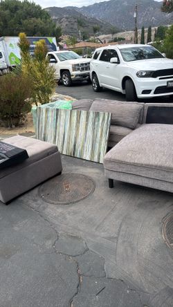 Sectional, wall art, and ottoman with storage
