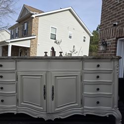 A Beautiful Vanity With Granite Top And Faucet 