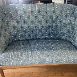 Blue patterned couch with wood frame