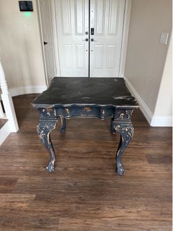 Distressed black ornate side table