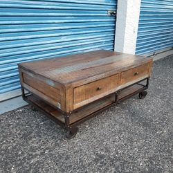 Urban Gold Coffee table. Wheels do not lock. Measures approx: 49" wide x 30" deep x 20.5" tall. 