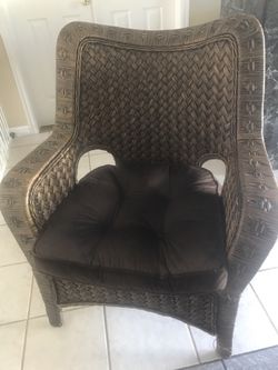 Brown wicker chair with cushion