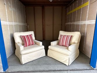 Two cream colored arm chairs