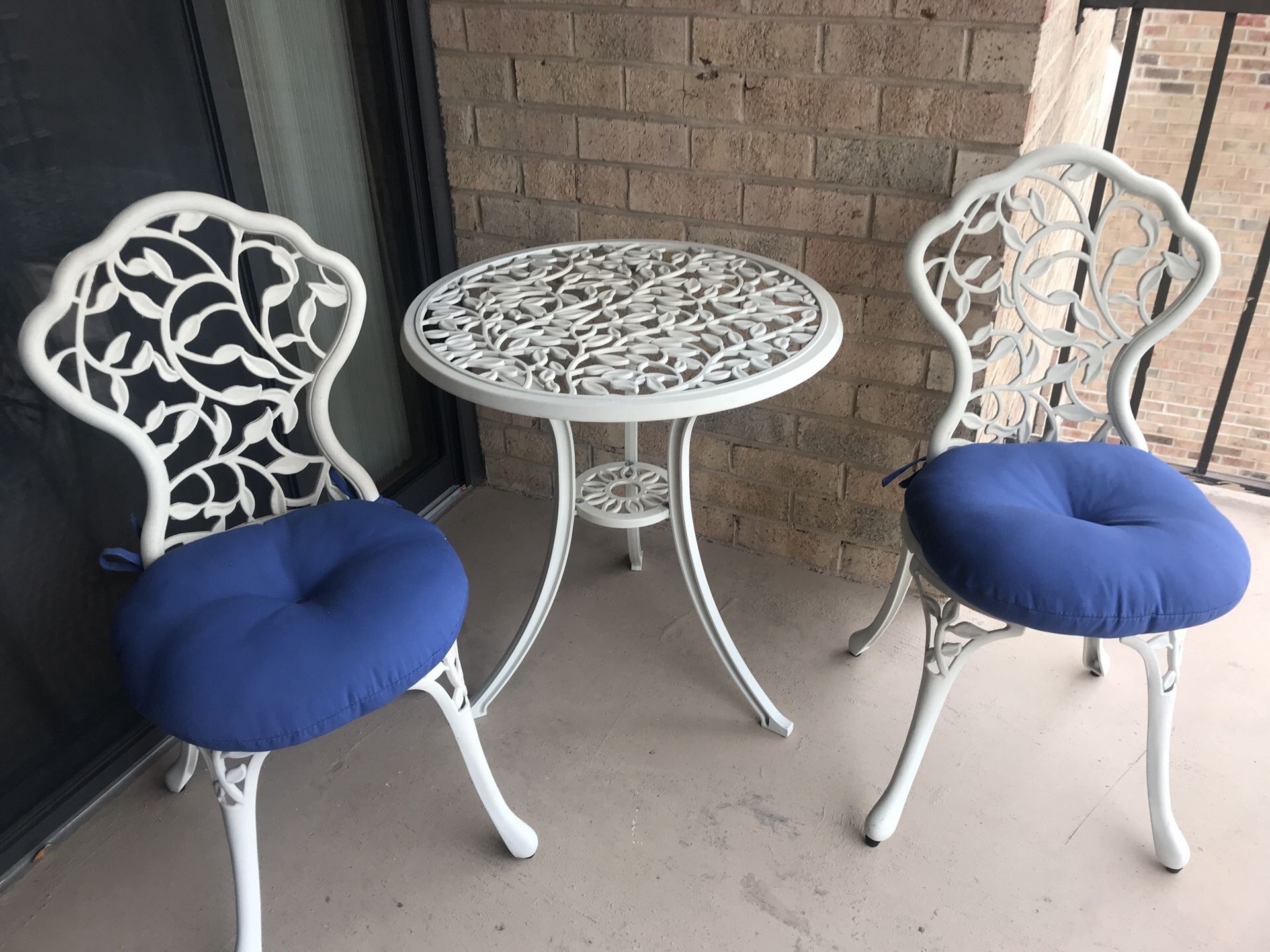 Patio table and chairs with cushions